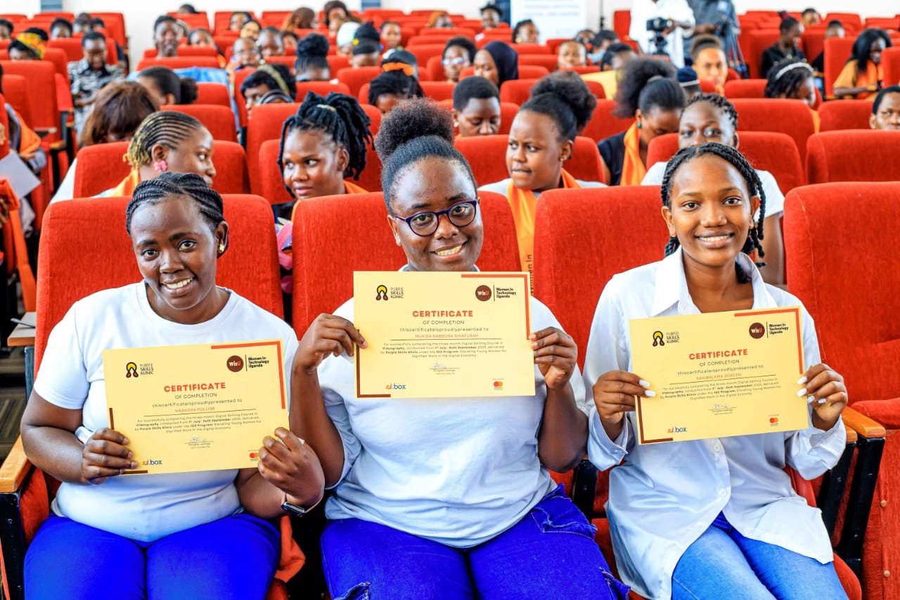 Three graduates holding their certificates of completion